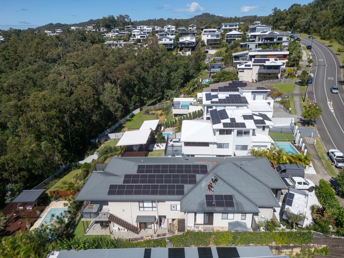 Aerial view of suburban rooftops on a green hillside
