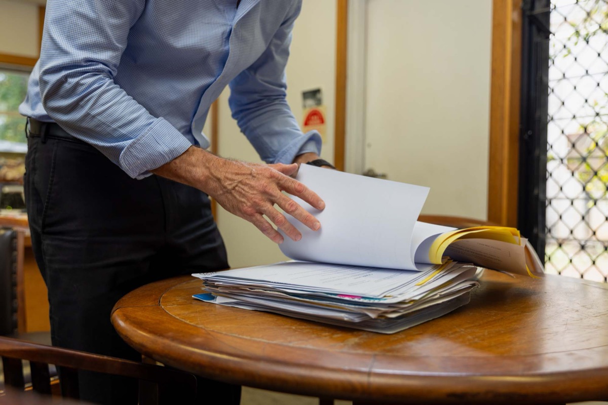 A professional reviewing documents at a desk