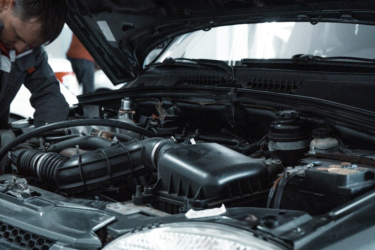 A mechanic working on a car headlight