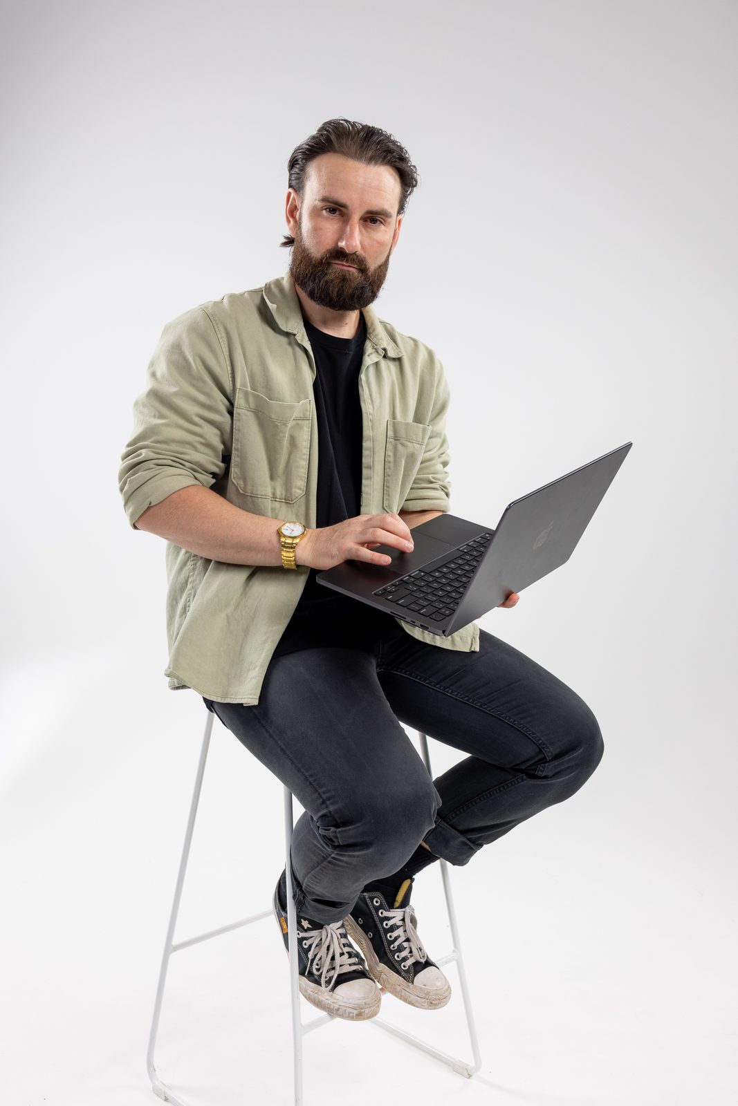 Stackt co-founder working on a laptop in the studio